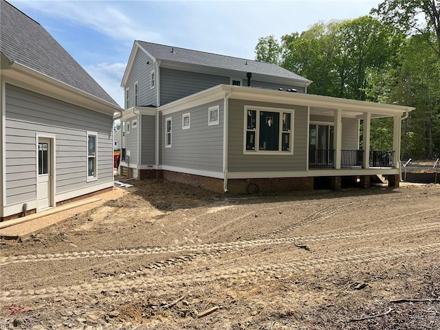 rear view of house featuring covered porch