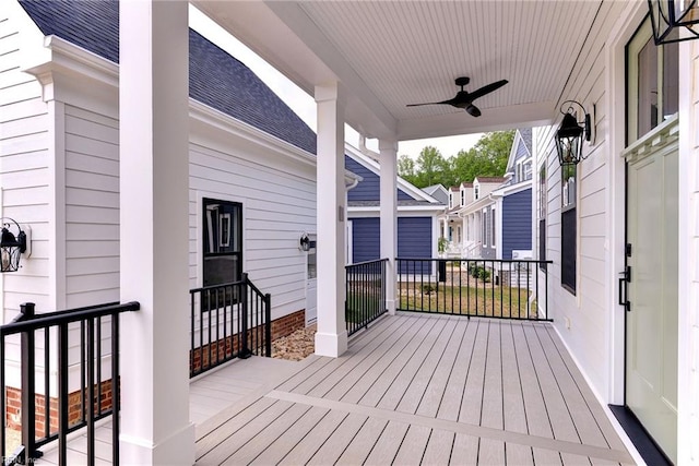 wooden terrace with covered porch and ceiling fan