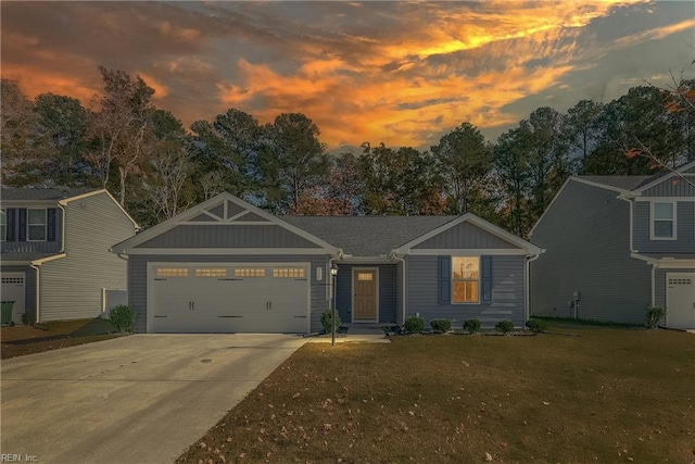 view of front of home featuring a yard and a garage