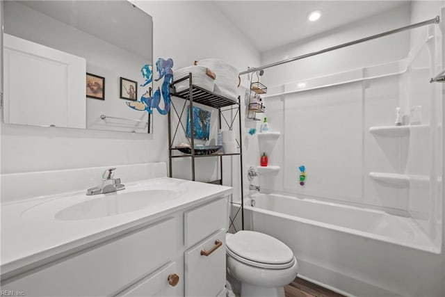 full bathroom with vanity, toilet, wood-type flooring, and washtub / shower combination