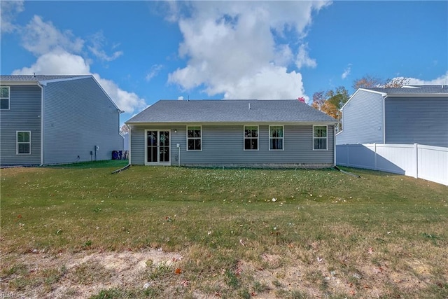 back of house featuring a lawn