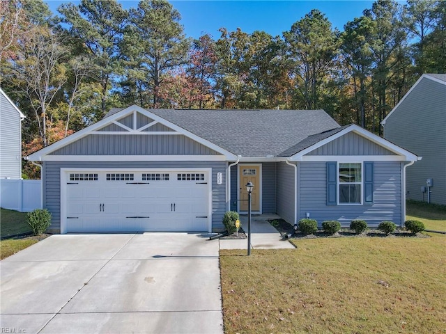 view of front of property with a garage and a front lawn