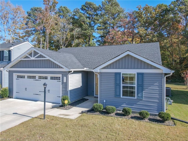 view of front facade featuring central AC, a front yard, and a garage