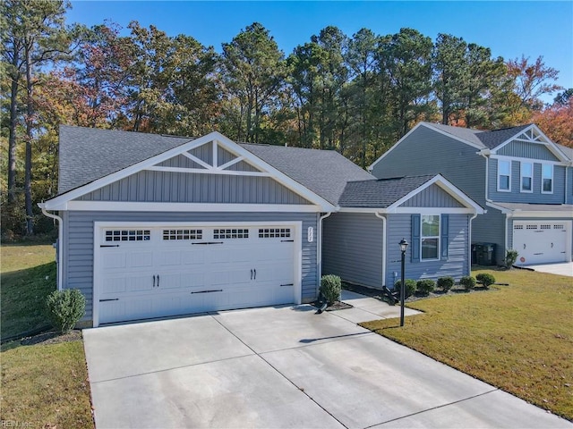 view of front of property featuring a front lawn and a garage