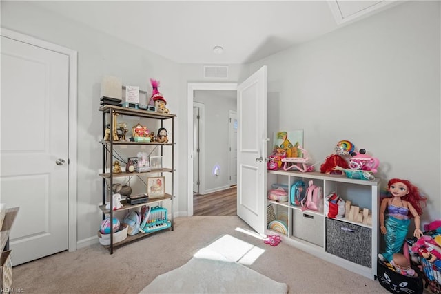 recreation room featuring light carpet