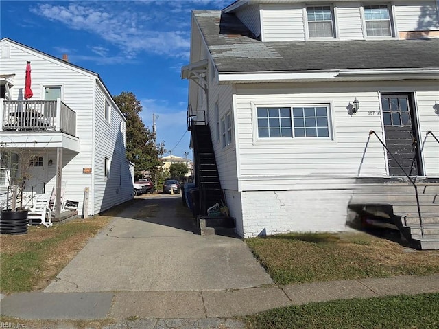 view of side of home featuring a balcony