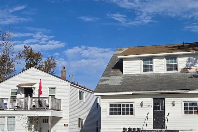 rear view of property featuring a balcony