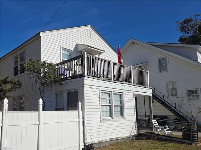 rear view of property featuring a balcony