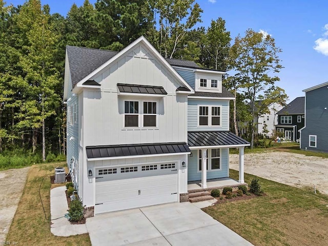 view of front facade with a front yard, cooling unit, a garage, and covered porch