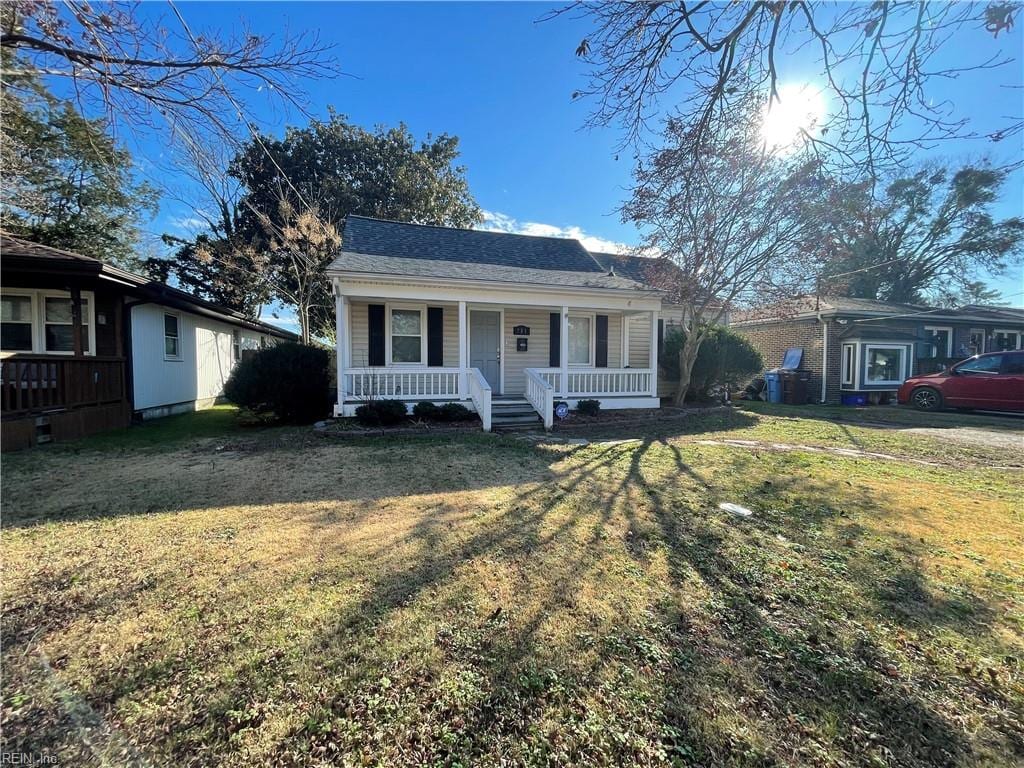 view of front of property with a front yard and a porch