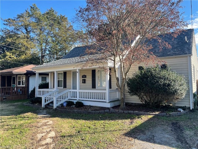 view of front facade with a front lawn and a porch