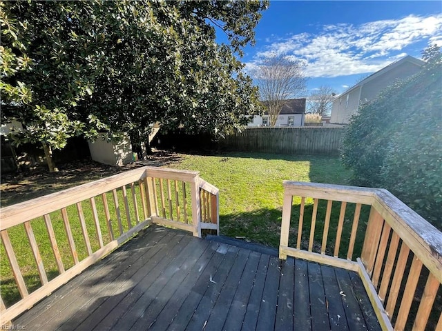 wooden terrace featuring a yard