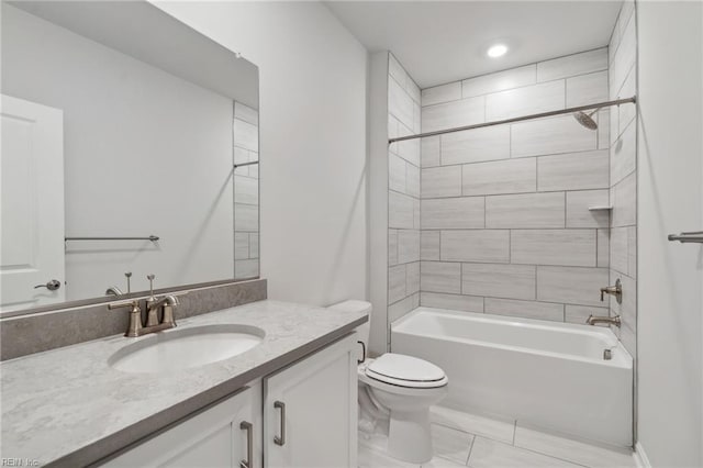 full bathroom with tiled shower / bath, vanity, and toilet