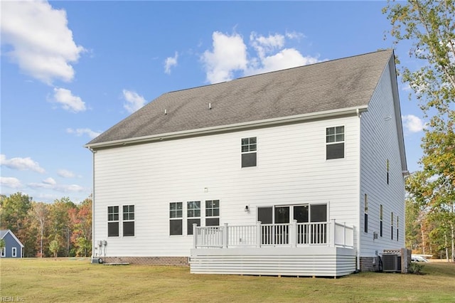 back of house featuring central AC and a lawn