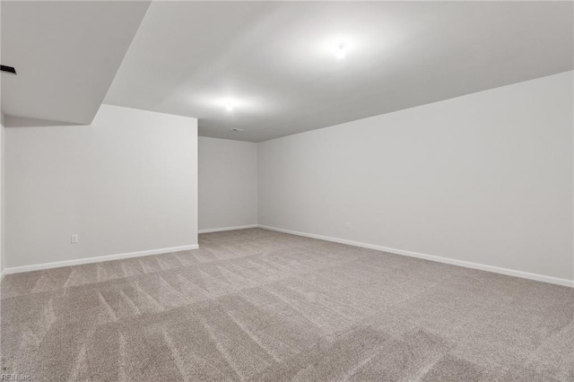 basement featuring light colored carpet