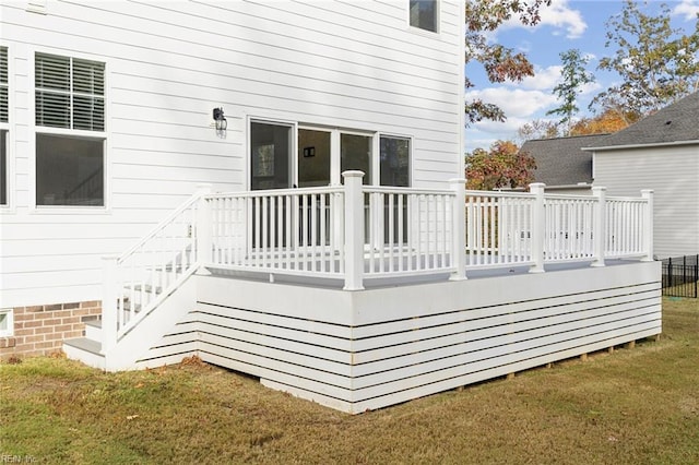 wooden terrace featuring a yard