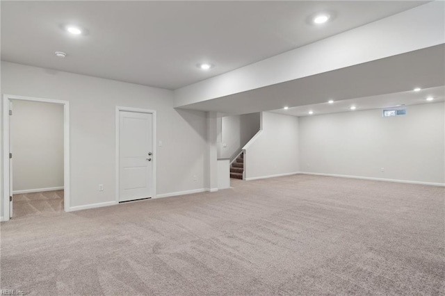 basement featuring light colored carpet