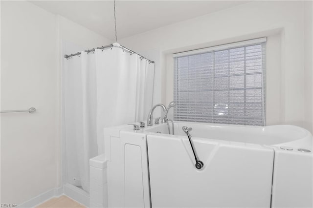 bathroom featuring separate shower and tub