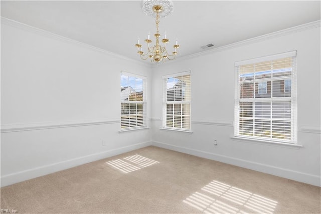 carpeted empty room featuring an inviting chandelier and ornamental molding