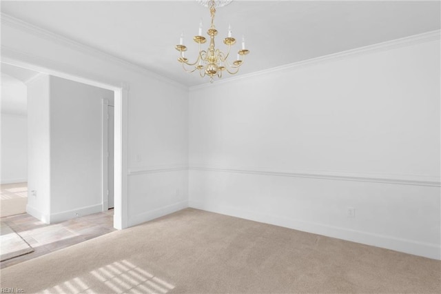 empty room with ornamental molding, a chandelier, and light colored carpet