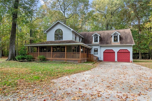 view of front of house with a front lawn, a garage, and covered porch