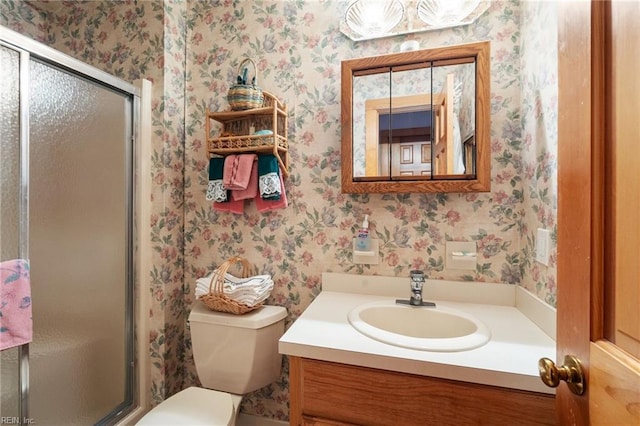 bathroom featuring vanity, toilet, and an enclosed shower