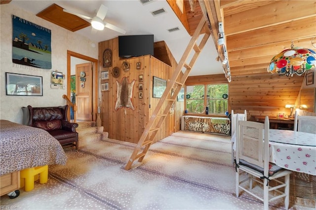 bedroom with wooden walls and ceiling fan