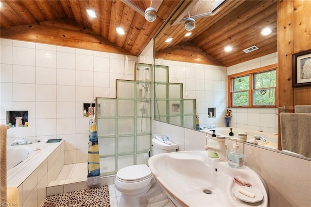 full bathroom with tile walls, independent shower and bath, vaulted ceiling, tile patterned flooring, and toilet