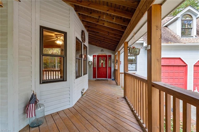 wooden deck with a garage and covered porch