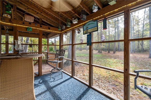 sunroom / solarium featuring wood ceiling and vaulted ceiling with beams