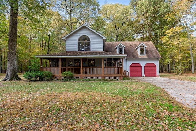 view of front of home featuring a front yard, a garage, an outdoor structure, and a porch