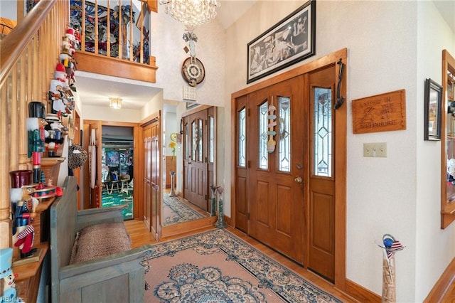 entryway with an inviting chandelier and wood-type flooring