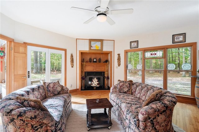 living room with ceiling fan and light wood-type flooring