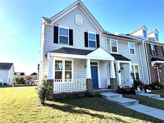 view of front of property with covered porch and a front lawn