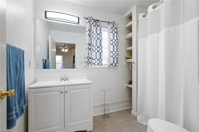 bathroom featuring vanity, toilet, and ceiling fan