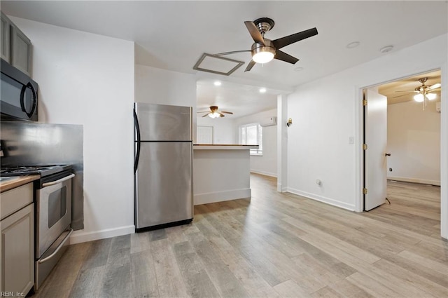 kitchen featuring gray cabinets, kitchen peninsula, stainless steel appliances, and light wood-type flooring