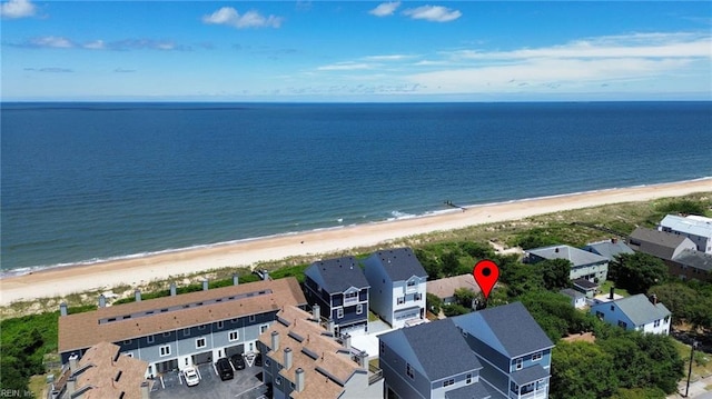 birds eye view of property featuring a water view and a beach view