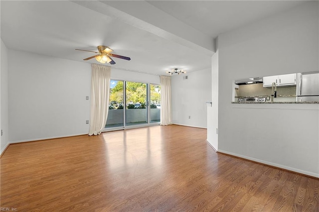 unfurnished living room featuring light wood-type flooring and ceiling fan