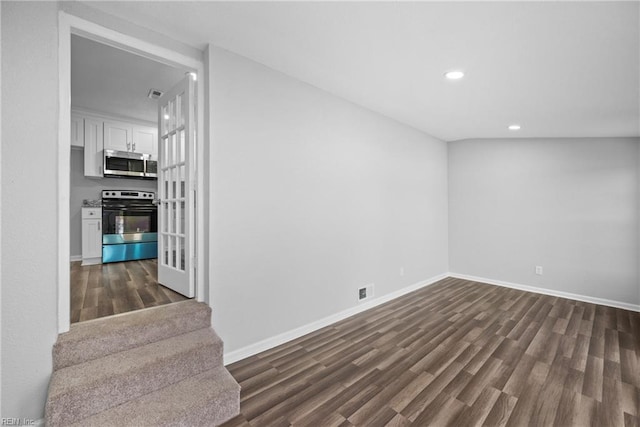 spare room featuring dark wood-type flooring