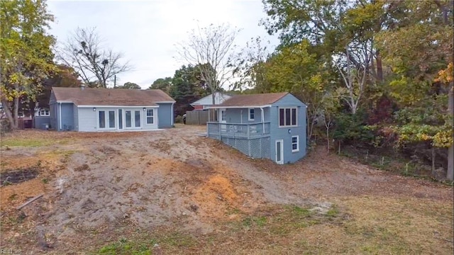 back of house featuring an outbuilding