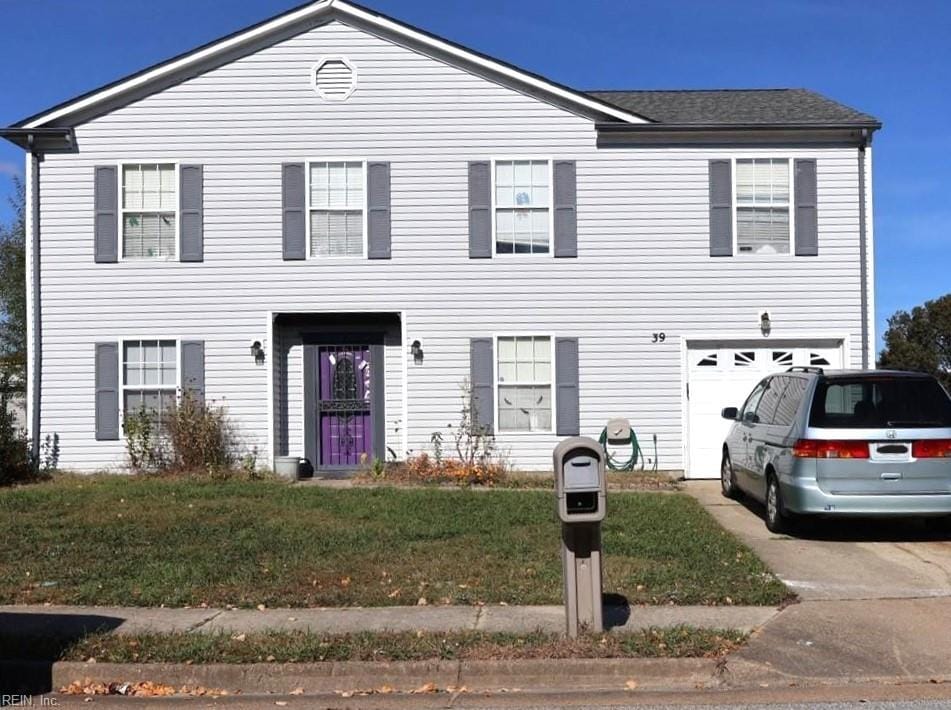 view of front facade with a front yard and a garage