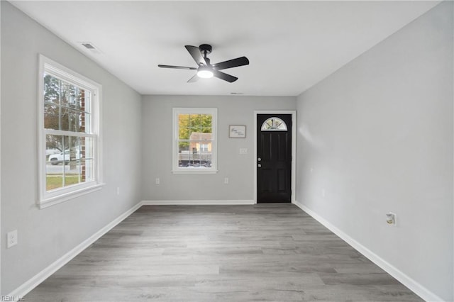 foyer entrance with light hardwood / wood-style floors and ceiling fan