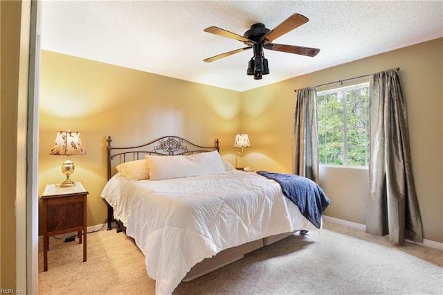 carpeted bedroom featuring a textured ceiling and ceiling fan