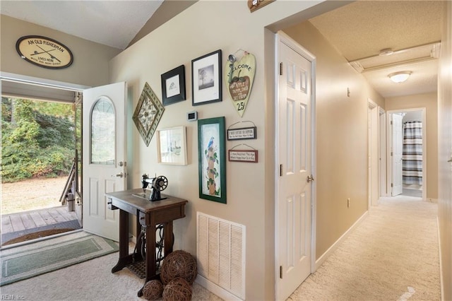 view of carpeted entrance foyer