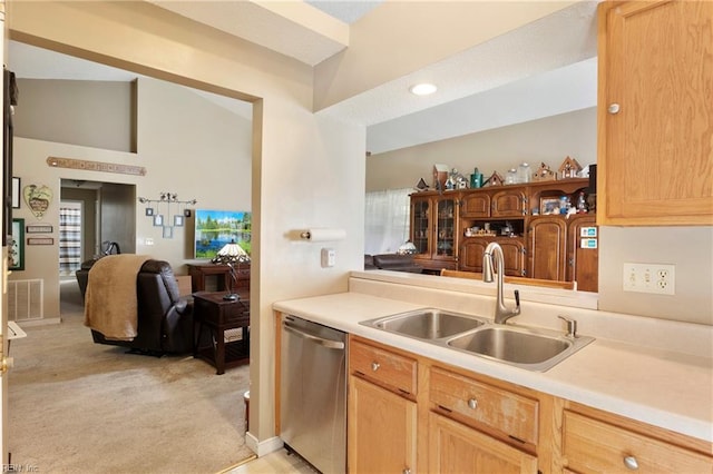 kitchen featuring light carpet, light brown cabinetry, sink, and stainless steel dishwasher