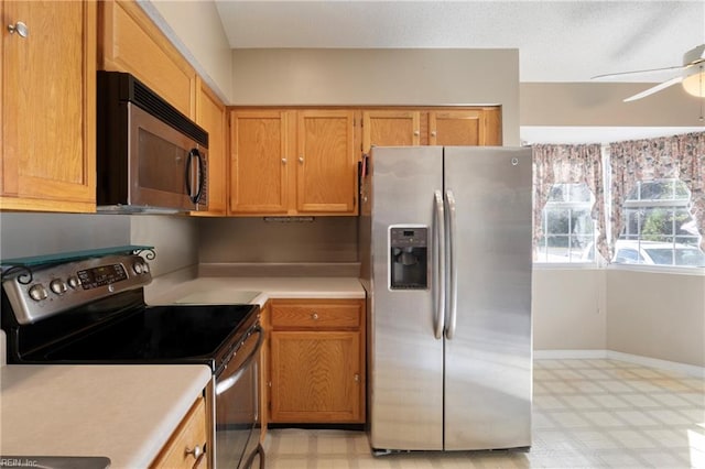 kitchen featuring ceiling fan and stainless steel appliances