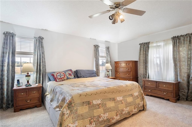 carpeted bedroom with multiple windows and ceiling fan