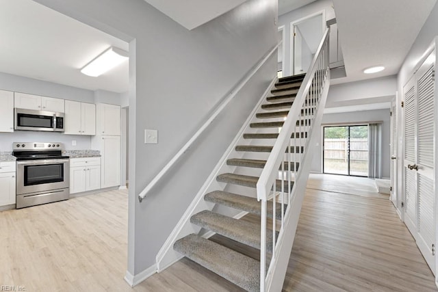 stairs featuring wood-type flooring