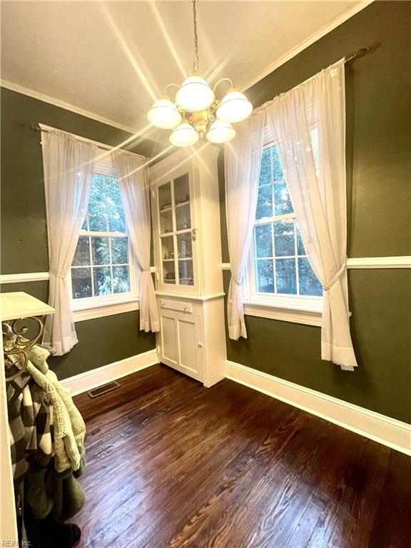 interior space with ornamental molding, dark wood-type flooring, and a wealth of natural light