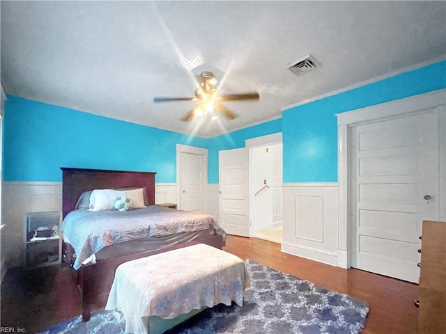 bedroom with wood-type flooring and ceiling fan